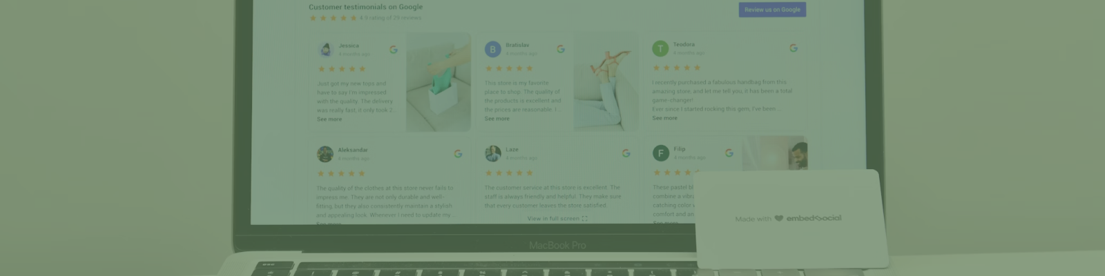 A laptop showcases a webpage filled with customer reviews and star ratings, hinting at expert Melbourne web design. In front, a closed business card holder labeled whiteboard adds a touch of professionalism.
