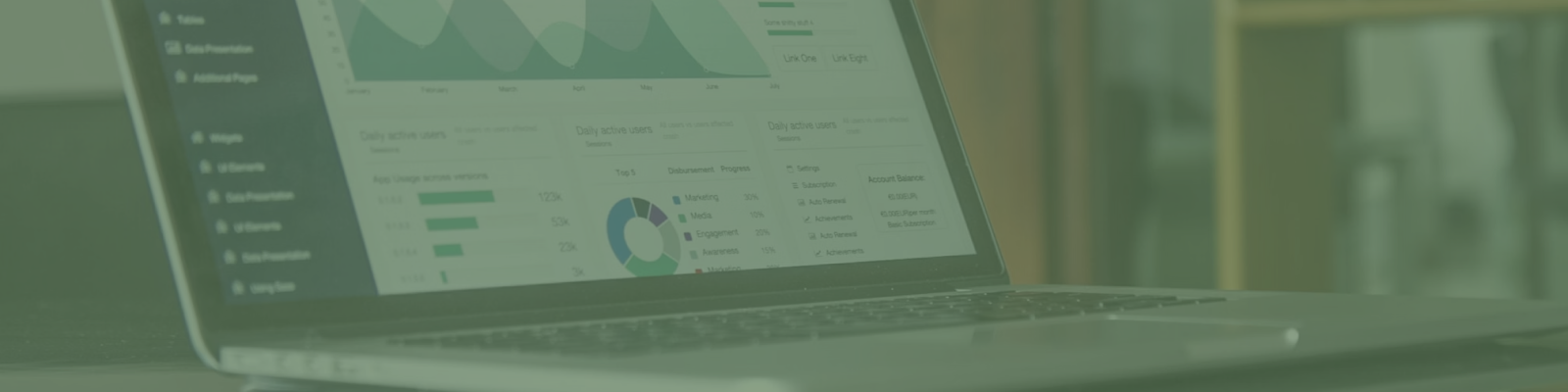 A laptop showcasing various data charts and graphs glows softly with a green tint, reminiscent of the trendy vibe youd find in a Melbourne web design café.